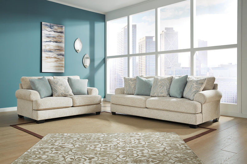 Ashley Furniture Monaghan living room set featuring a sofa, loveseat, and armchair with neutral fabric upholstery.