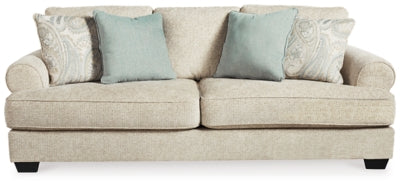 Ashley Furniture Monaghan sofa with plush cushions and neutral fabric, shown in a head-on view highlighting its inviting design.
