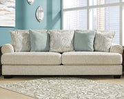 Ashley Furniture Monaghan living room set featuring a sofa and loveseat with neutral upholstery and wooden legs.