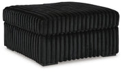 Ashley Furniture Midnight-Madness oversized accent ottoman with plush fabric and modern design, shown from an angled view.