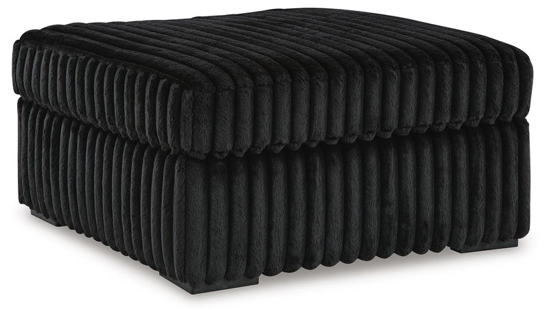 Ashley Furniture Midnight-Madness oversized accent ottoman with plush fabric and modern design, shown from an angled view.
