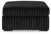 Ashley Furniture Midnight-Madness oversized accent ottoman with plush fabric and stylish design, shown from a side angle.