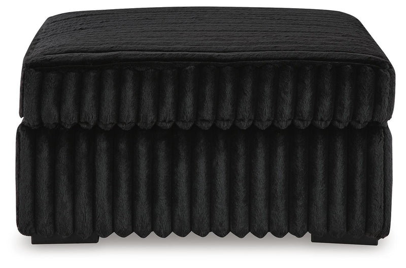 Ashley Furniture Midnight-Madness oversized accent ottoman with plush fabric and stylish design, shown from a side angle.