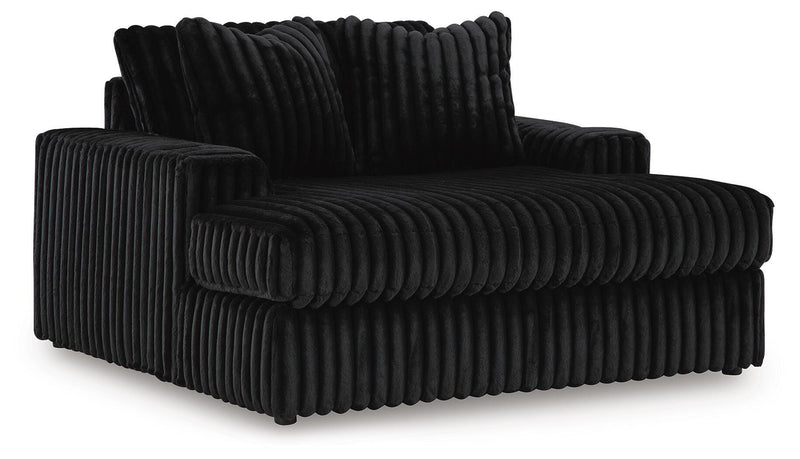 Ashley Furniture Midnight-Madness oversized chaise chair with plush upholstery, shown from an angled side view.