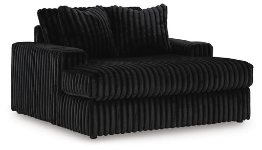 Ashley Furniture Midnight-Madness oversized chaise chair with plush upholstery, shown from an angled side view.