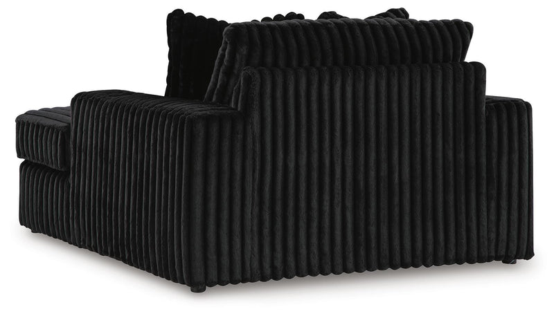 Ashley Furniture Midnight-Madness oversized chaise chair with plush upholstery and a modern design, shown from the back.