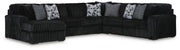 Ashley Furniture Midnight-Madness sectional with chaise, featuring plush cushions and modern design in a cozy living room setting.