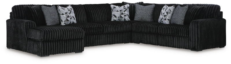 Ashley Furniture Midnight-Madness sectional with chaise, featuring plush cushions and modern design in a cozy living room setting.