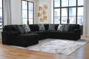 Ashley Furniture Midnight-Madness sectional with chaise, featuring plush upholstery and modern design in a stylish living room setting.