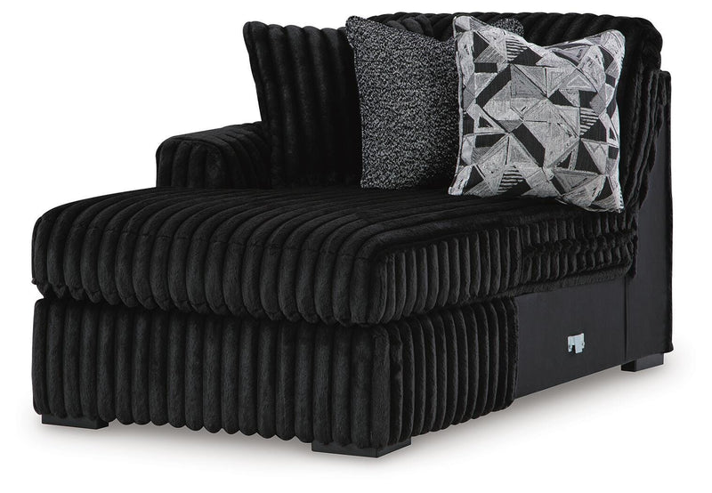 Ashley Furniture Midnight-Madness sectional with chaise, showcasing dark fabric upholstery and modern sectional design from an angled view.