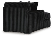 Ashley Furniture Midnight-Madness sectional with chaise, showing plush fabric, modern design, and spacious seating in a cozy living room setting.