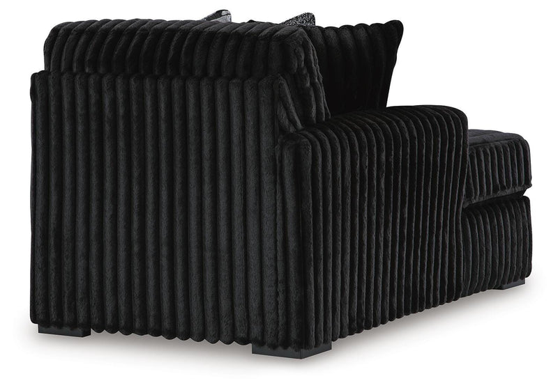 Ashley Furniture Midnight-Madness sectional with chaise, showing plush fabric, modern design, and spacious seating in a cozy living room setting.