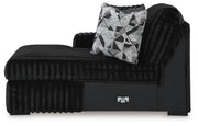 Ashley Furniture Midnight-Madness sectional with chaise, showing dark fabric upholstery and modern design in a spacious living room.