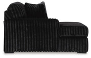 Ashley Furniture Midnight-Madness sectional with chaise, featuring plush cushions and dark upholstery, designed for comfortable living spaces.