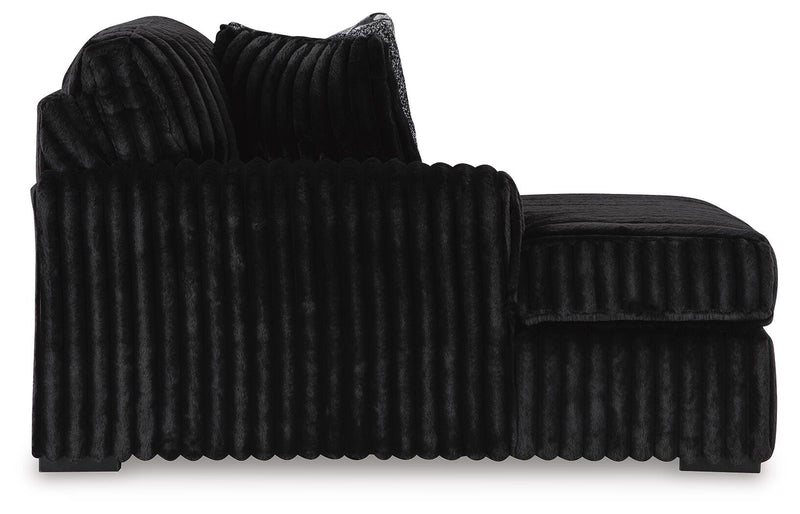 Ashley Furniture Midnight-Madness sectional with chaise, featuring plush cushions and dark upholstery, designed for comfortable living spaces.