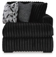 Ashley Furniture Midnight-Madness sectional with chaise, showing plush fabric, modern design, and a cozy seating arrangement.