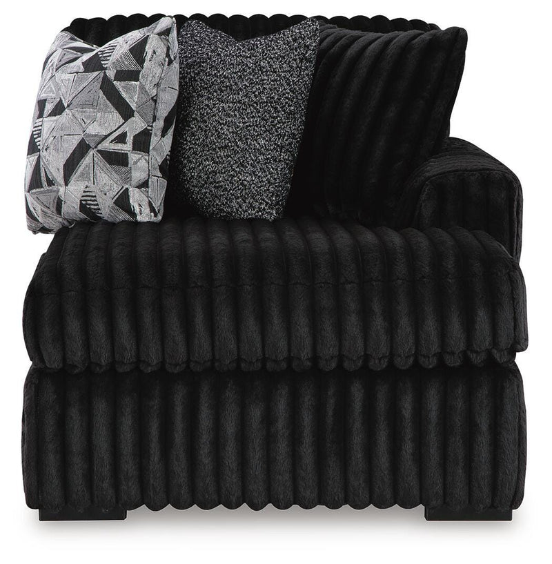 Ashley Furniture Midnight-Madness sectional with chaise, showing plush fabric, modern design, and a cozy seating arrangement.