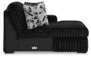 Ashley Furniture Midnight-Madness sectional with chaise, featuring plush upholstery and modern design in a stylish living room setting.