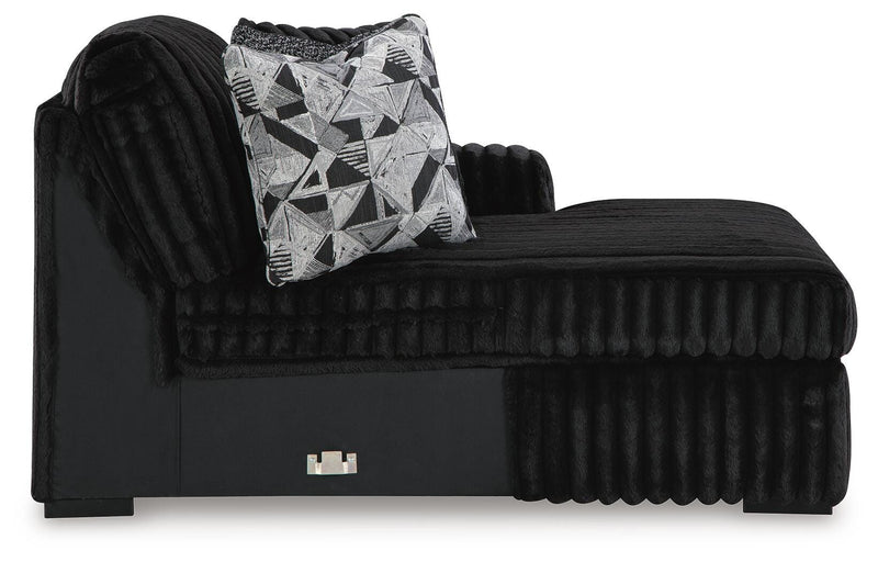 Ashley Furniture Midnight-Madness sectional with chaise, featuring plush upholstery and modern design in a stylish living room setting.