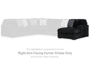 Ashley Furniture Midnight-Madness sectional with chaise, showing plush dark fabric, modern design, and spacious seating arrangement.