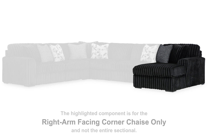 Ashley Furniture Midnight-Madness sectional with chaise, showing plush dark fabric, modern design, and spacious seating arrangement.