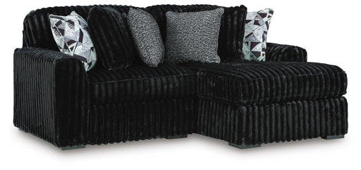 Ashley Furniture Midnight-Madness sectional with chaise, showing dark fabric upholstery and modern design from an angled view.