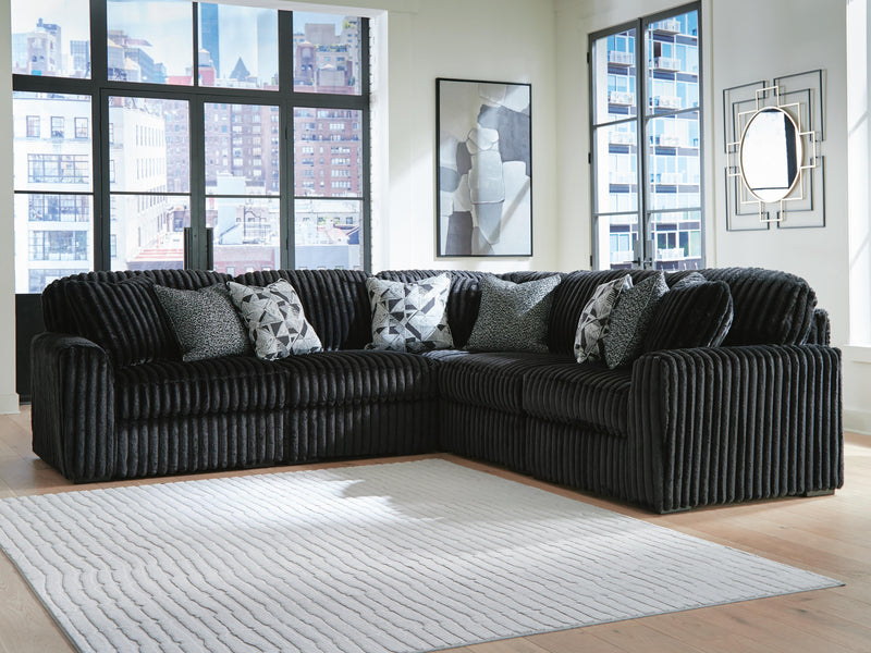 Ashley Furniture Midnight-Madness sectional sofa with plush cushions and modern design, shown in a cozy living room setting.