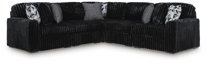 Ashley Furniture Midnight-Madness sectional sofa with plush cushions and dark fabric, shown in a stylish living room setting.