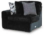 Ashley Furniture Midnight-Madness sectional sofa shown from an angled view, featuring plush cushions and dark upholstery.