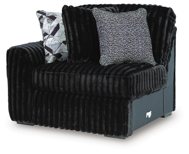 Ashley Furniture Midnight-Madness sectional sofa shown from an angled view, featuring plush cushions and dark upholstery.