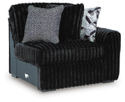 Ashley Furniture Midnight-Madness sectional sofa with plush cushions and modern design, shown from an angled side view.