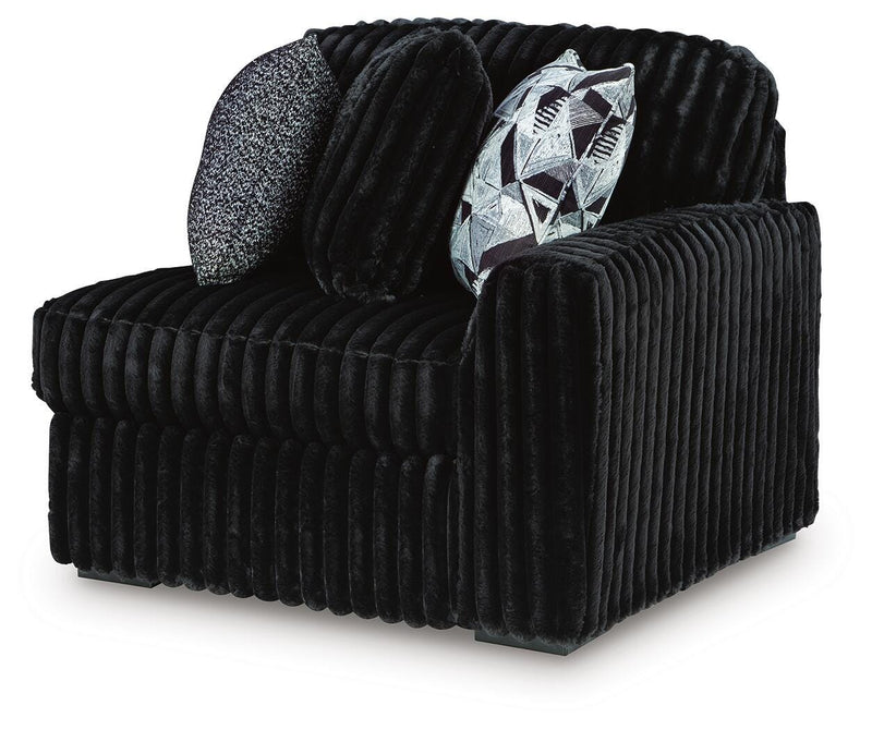 Ashley Furniture Midnight-Madness sectional sofa shown from an angled view, featuring plush upholstery and modern design.