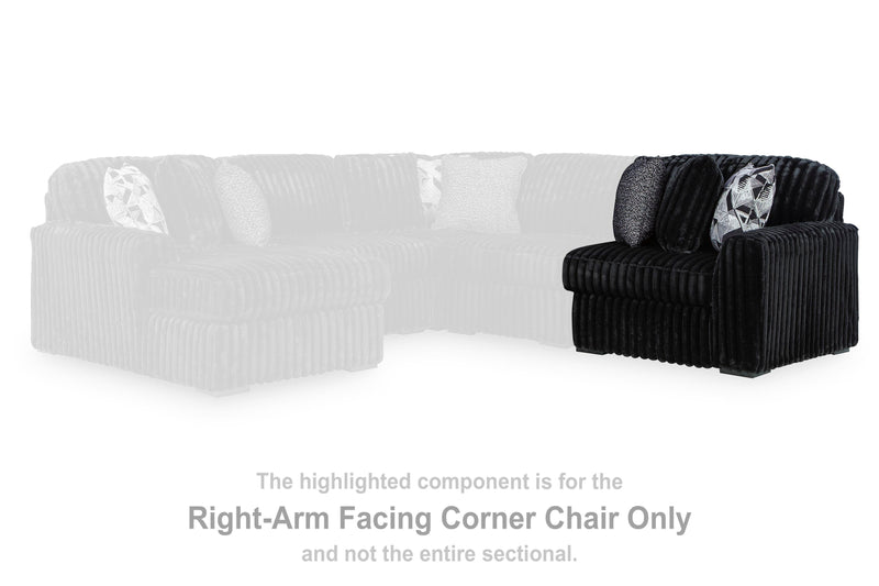 Ashley Furniture Midnight-Madness sectional sofa with plush cushions and dark upholstery, shown in a stylish living room setting.