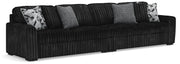 Ashley Furniture Midnight-Madness sectional sofa with plush cushions and dark fabric upholstery, shown in a spacious living room setting.