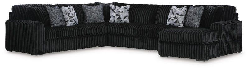 Ashley Furniture Midnight-Madness sectional with chaise, showing dark fabric upholstery and modern design in a living room setting
