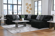 Ashley Furniture Midnight-Madness sectional with chaise, featuring dark upholstery and plush cushions in a modern living room setting.