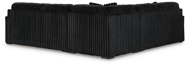 Ashley Furniture Midnight-Madness sectional with plush cushions and dark fabric, viewed from the back showing seating arrangement.