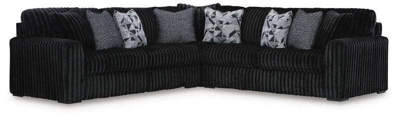 Ashley Furniture Midnight-Madness sectional with plush fabric, featuring a modern L-shaped sofa with multiple cushions and sleek design.