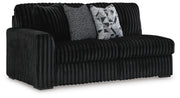 Ashley Furniture Midnight-Madness sectional sofa shown from an angled view, featuring plush cushions and modern design.