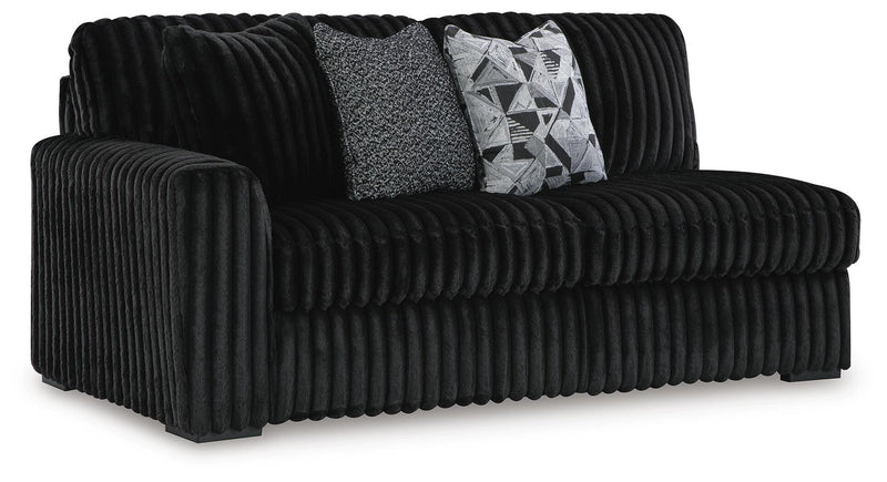 Ashley Furniture Midnight-Madness sectional with chaise, angled view showing plush fabric, modern design, and spacious seating.
