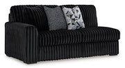 Ashley Furniture Midnight-Madness sectional shown from an angled view, featuring plush cushions and dark fabric upholstery.