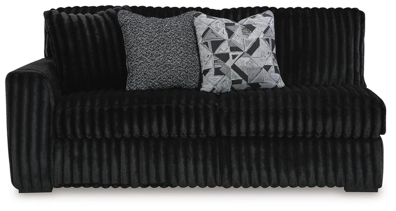Ashley Furniture Midnight-Madness sectional with chaise, featuring dark upholstery and plush cushions, viewed from the head-on angle.