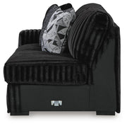 Ashley Furniture Midnight-Madness sectional with chaise, showing dark fabric upholstery and modern design in a living room setting.