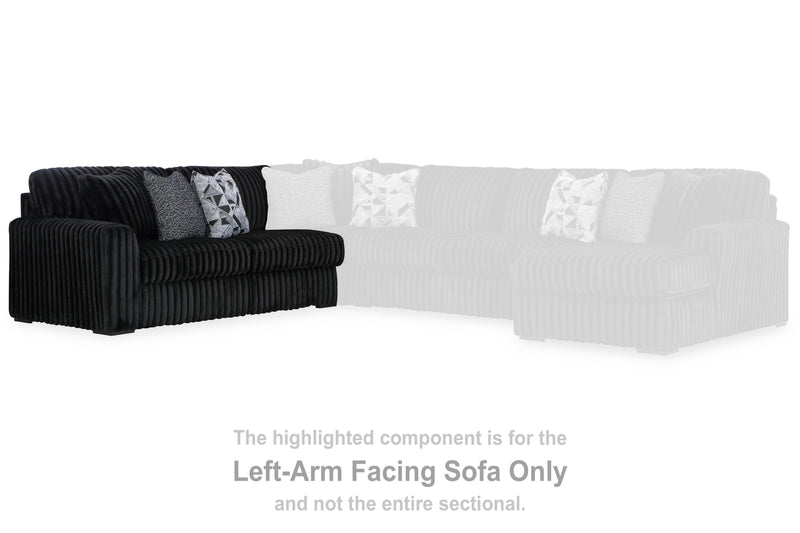 Ashley Furniture Midnight-Madness sectional sofa with plush cushions and dark upholstery, shown in a modern living room setting.