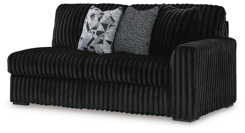 Ashley Furniture Midnight-Madness sectional with chaise, showing a modern L-shaped sectional with dark upholstery and plush cushions.