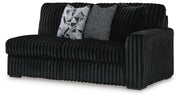 Ashley Furniture Midnight-Madness sectional, angled view showcasing plush fabric and modern design with multiple seating areas.