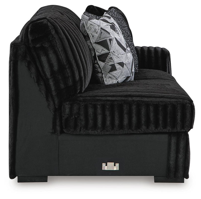 Ashley Furniture Midnight-Madness sectional with chaise, featuring plush upholstery and modern design in a stylish living room setting.
