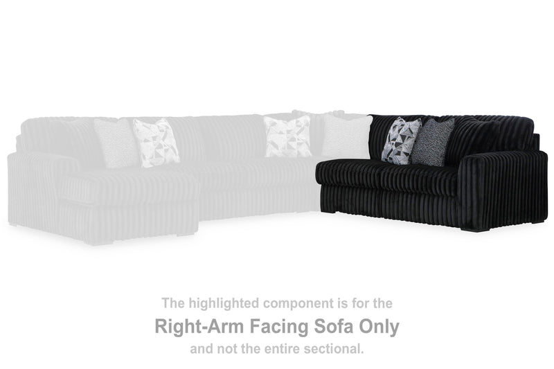 Ashley Furniture Midnight-Madness sectional sofa with plush cushions and dark fabric, shown in a modern living room setting.