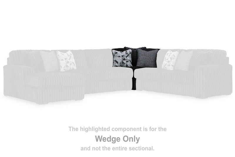 Ashley Furniture Midnight-Madness sectional sofa with plush cushions and dark fabric, shown in a cozy, modern living room setting.