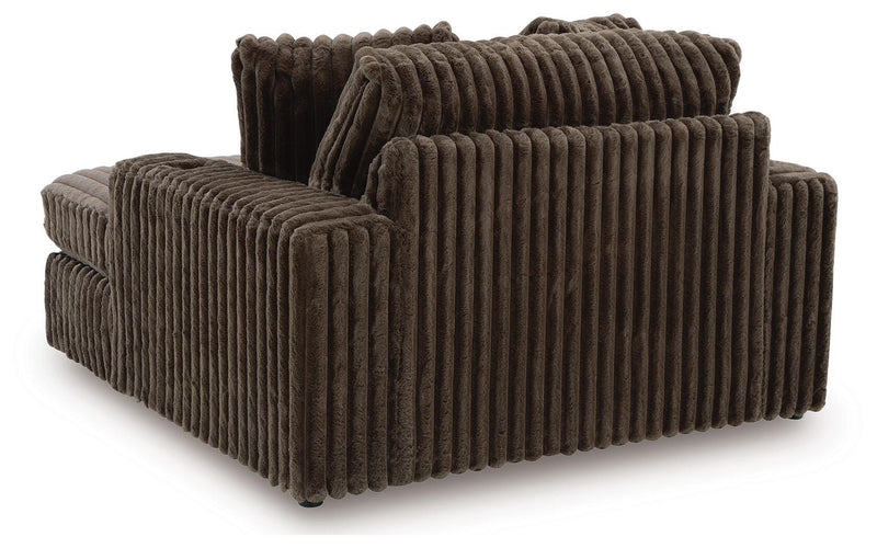 Ashley Furniture Midnight-Madness Oversized Chaise chair with plush fabric and wide seating, shown from the back in a modern living space.